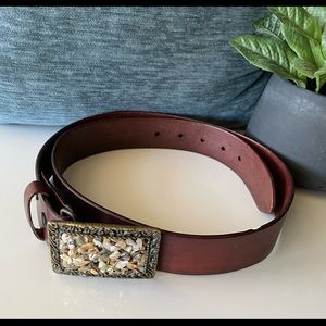 Genuine leather belt with embellished stones on buckle.
